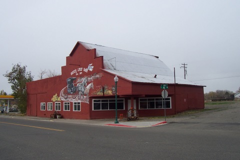 A neat old building that use to be a barn, then a auto shop. I took the picture because of the artword on the side of the building. It looks abandoned inside when you peer in the windows. This is right downtown. On a Thursday afternoon.